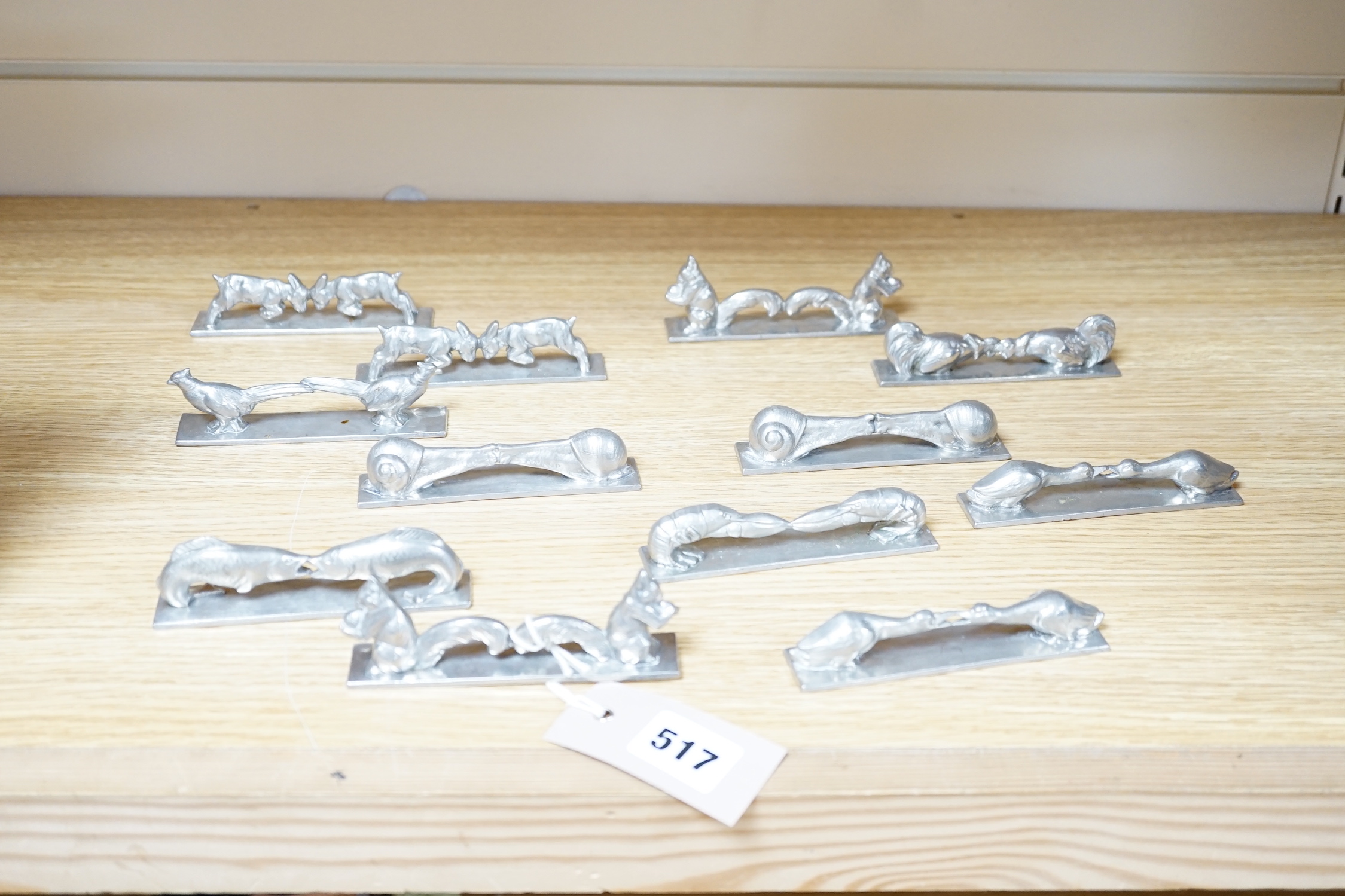 A set of 12 French pewter novelty knife rests, in the form of squirrels, fish, snails, goats, etc.